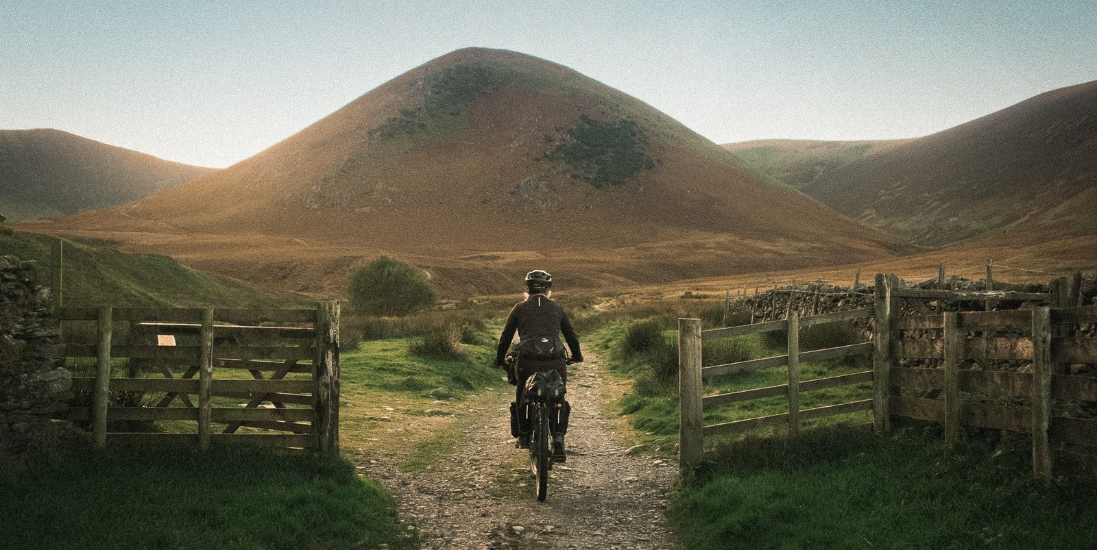 Woman cycling into the mountains - Josh and Sarah Ride